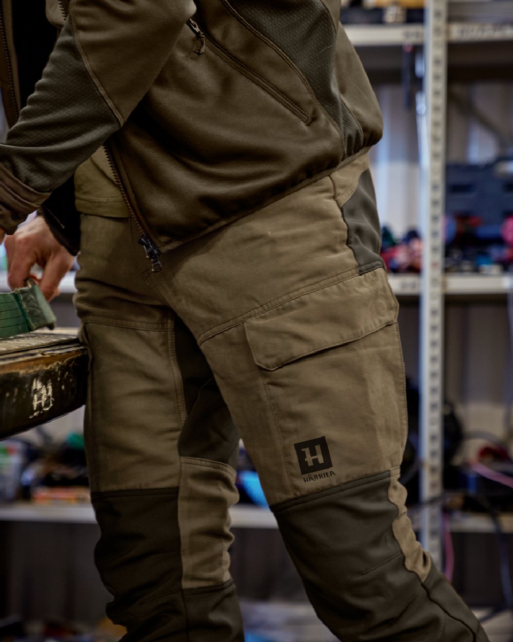 Dark Olive Willow Green Coloured Harkila Scandinavian Trousers on outdoor background #colour_dark-olive-willow-green