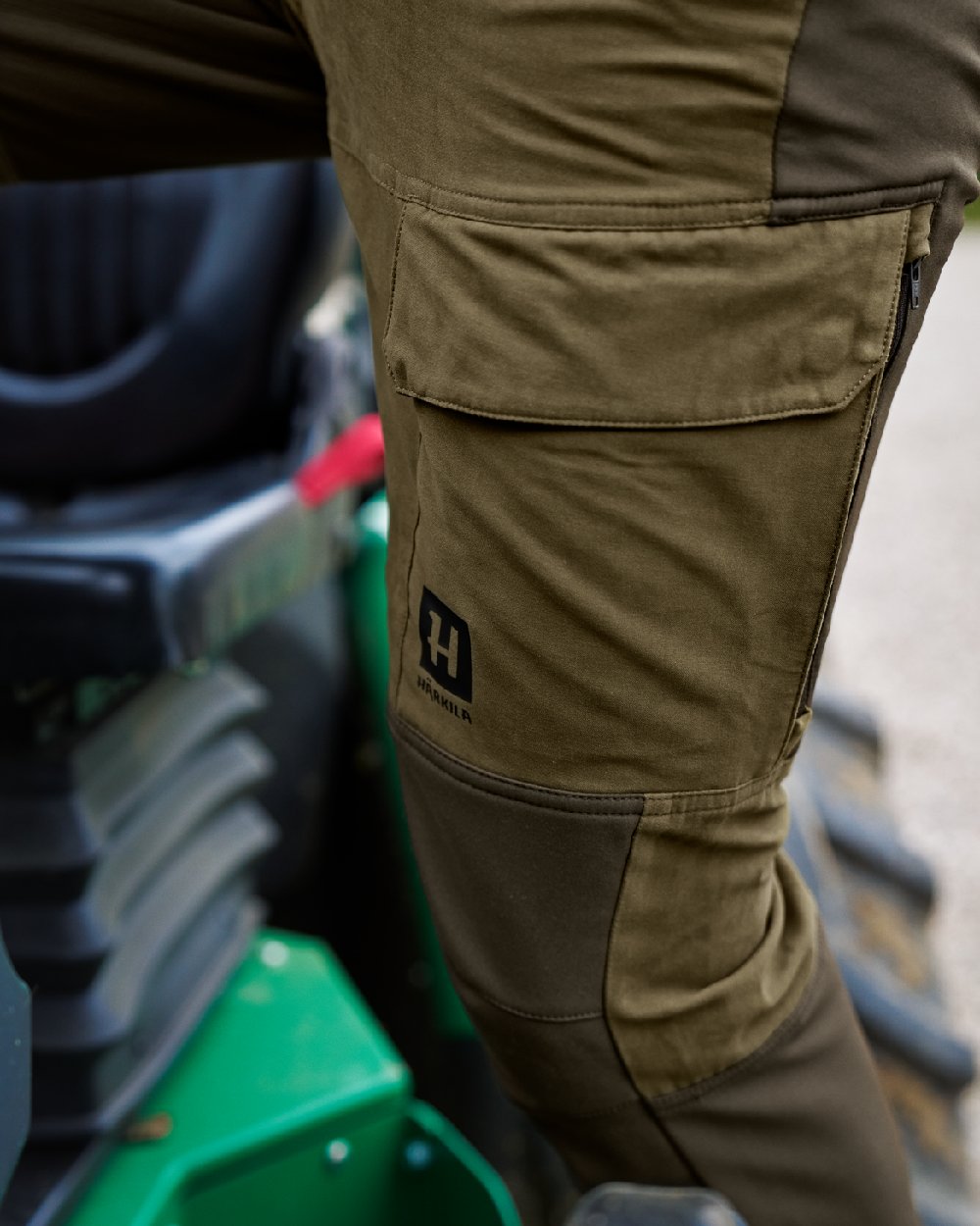 Dark Olive Willow Green Coloured Harkila Scandinavian Trousers on outdoor background #colour_dark-olive-willow-green