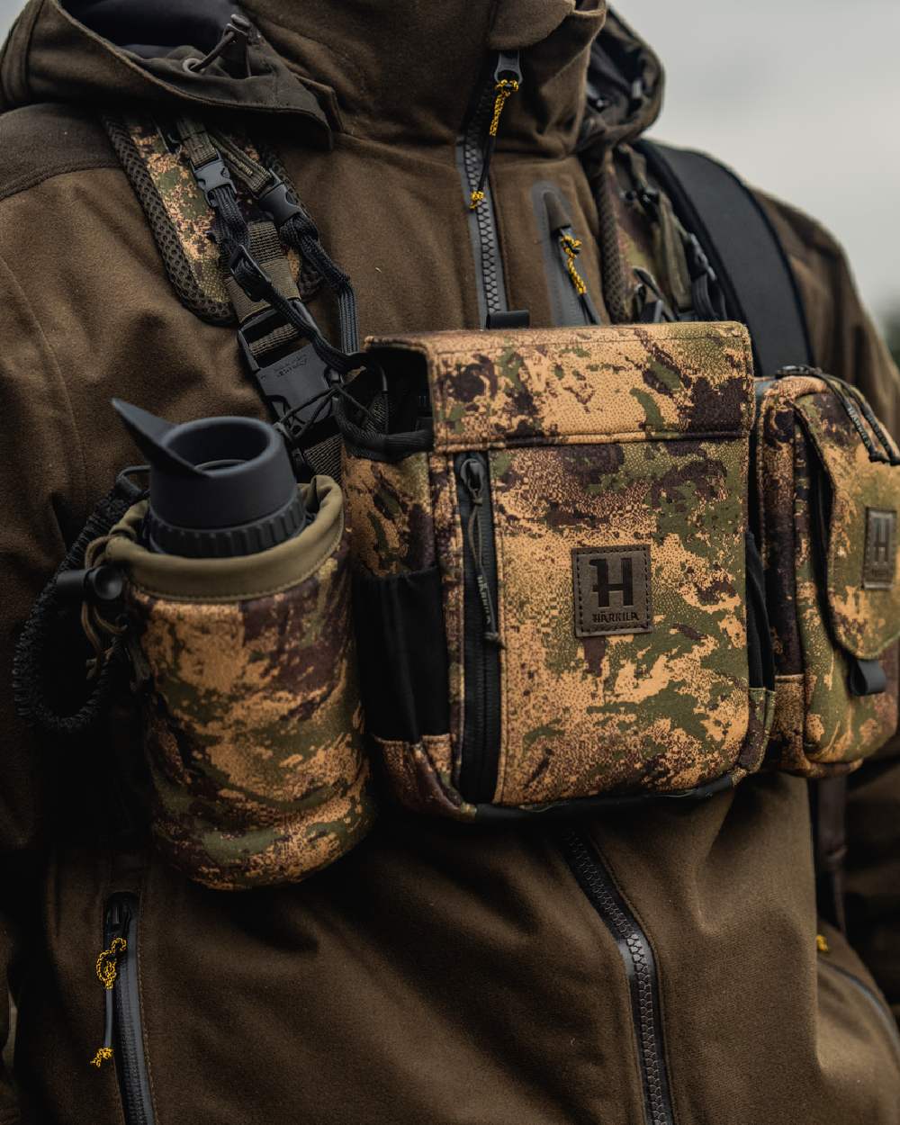 AXIS MSPForest Coloured Harkila Thermal Camo Spotter Pouch on blurry background #colour_axis-mspforest