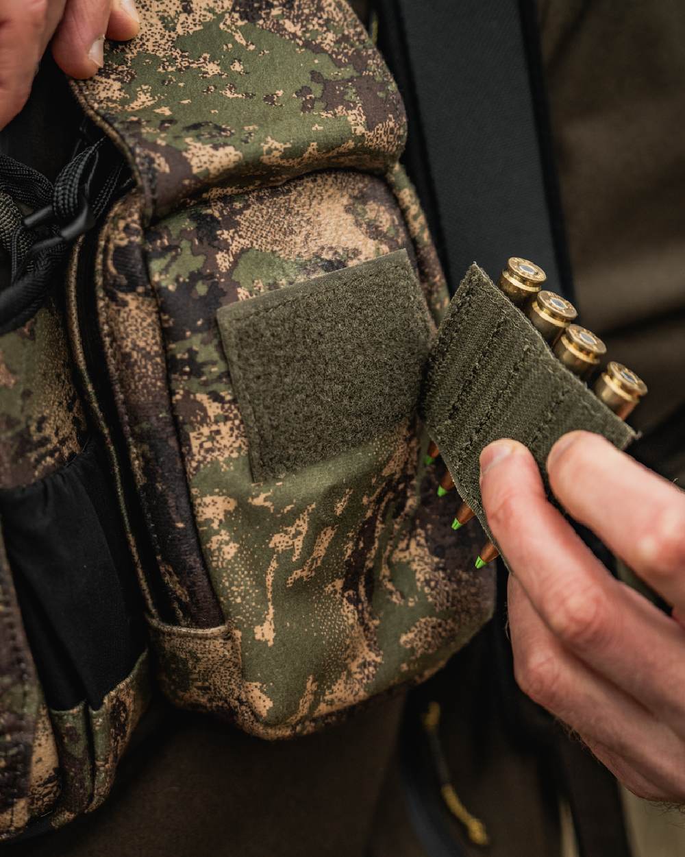 AXIS MSPForest Coloured Harkila Utility Camo Pouch on blurry background #colour_axis-mspforest