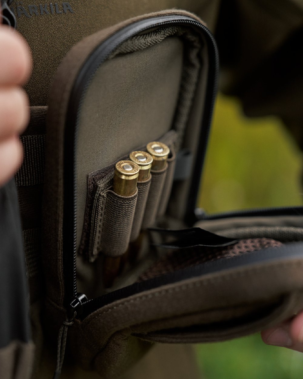 Dark Willow Green Coloured Harkila Utility Pouch on blurry background #colour_dark-willow-green