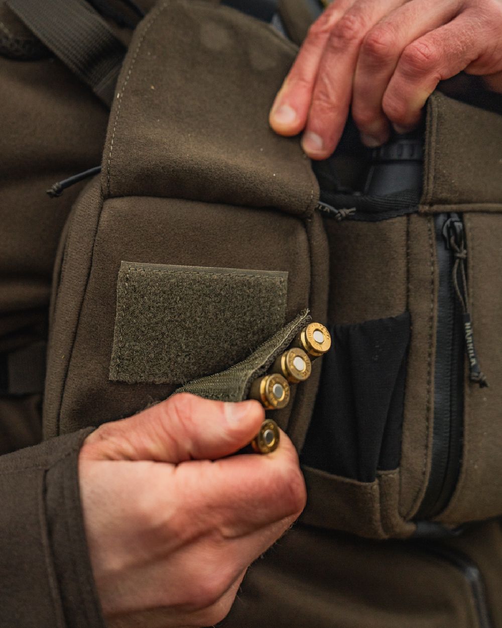 Dark Willow Green Coloured Harkila Utility Pouch on blurry background #colour_dark-willow-green