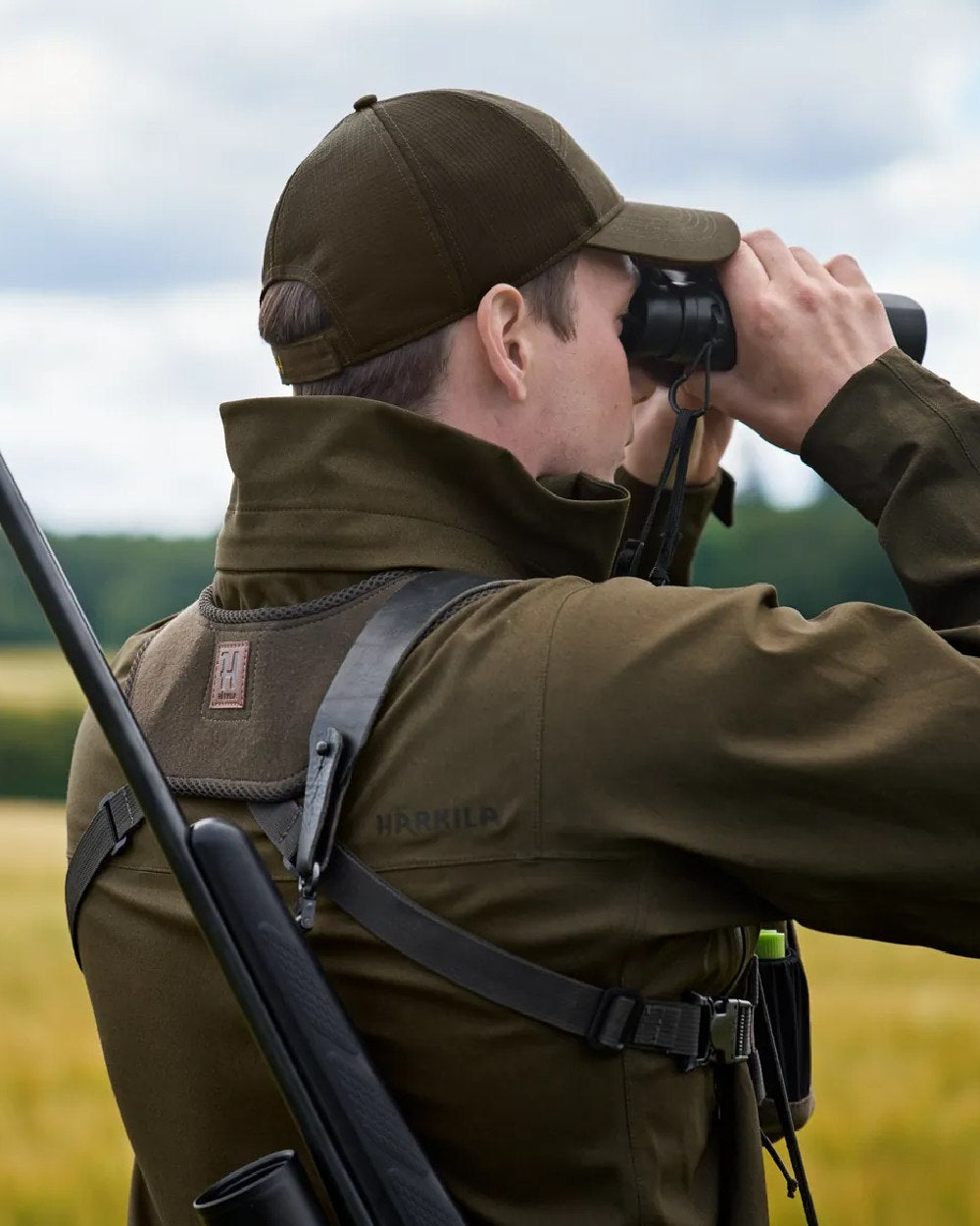 Dark Willow Green Coloured Harkila Utility Pouch on blurry background #colour_dark-willow-green