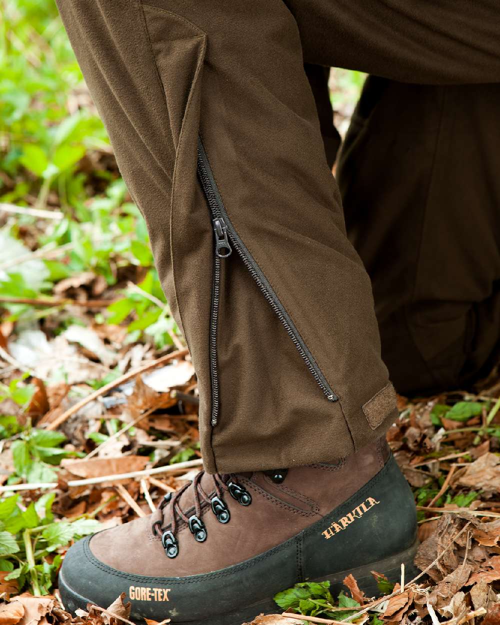 Hunting Green Coloured Harkila Visent Trousers on outdoor background #colour_hunting-green