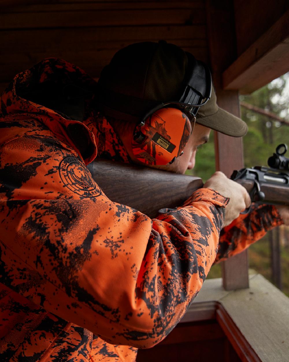 AXIS Orange Blaze Coloured Harkila Wildboar Pro HWS Insulated Jacket on outdoor background #colour_axis-orange-blaze