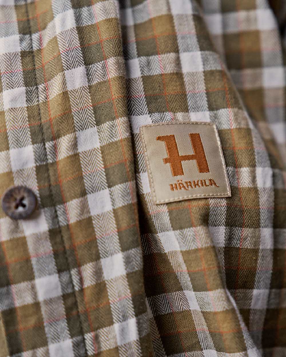 Dark Olive Check Coloured Harkila Womens Fjell Long Sleeve Shirt on blurry background #colour_dark-olive-check