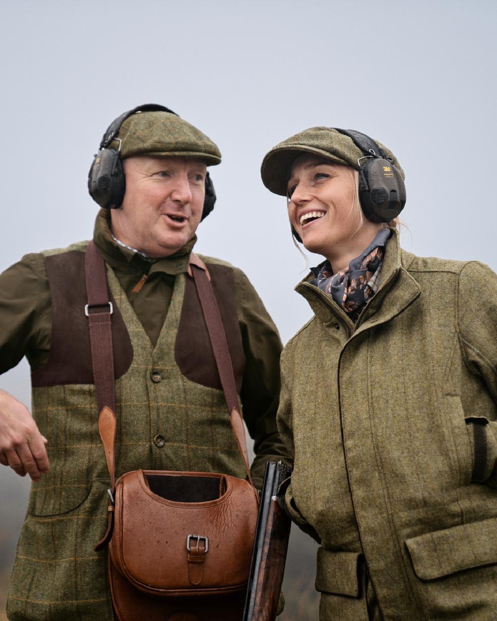 Olive Coloured Harkila Womens Jura GTX Jacket on fog background #colour_olive