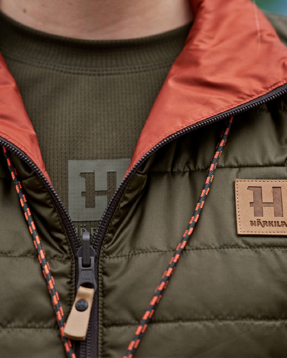 Willow Green Arabian Spice Coloured Harkila Womens Kalix HSP Waistcoat on blurry background #colour_willow-green-arabian-spice