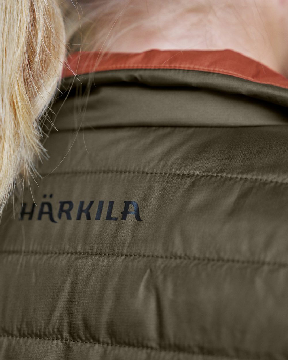 Willow Green Arabian Spice Coloured Harkila Womens Kalix HSP Waistcoat on blurry background #colour_willow-green-arabian-spice