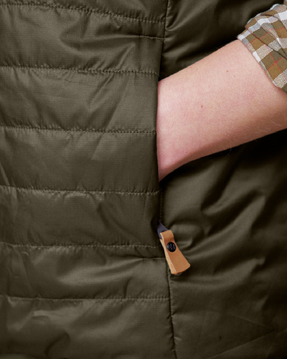 Willow Green Arabian Spice Coloured Harkila Womens Kalix HSP Waistcoat on blurry background #colour_willow-green-arabian-spice