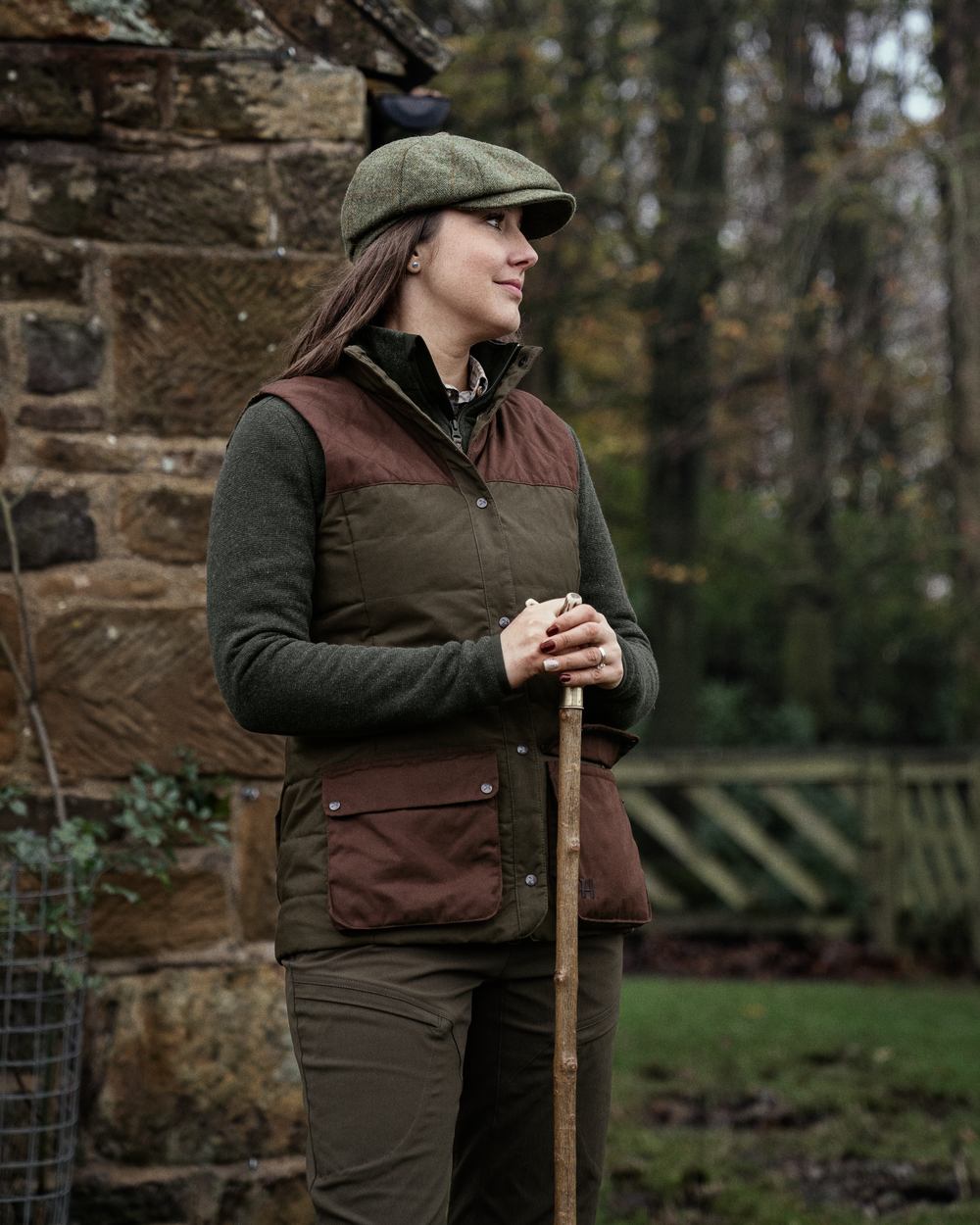 Dark Warm Olive Burgundy Coloured Harkila Womens Retrieve Waistcoat on outdoor background #colour_dark-warm-olive-burgundy