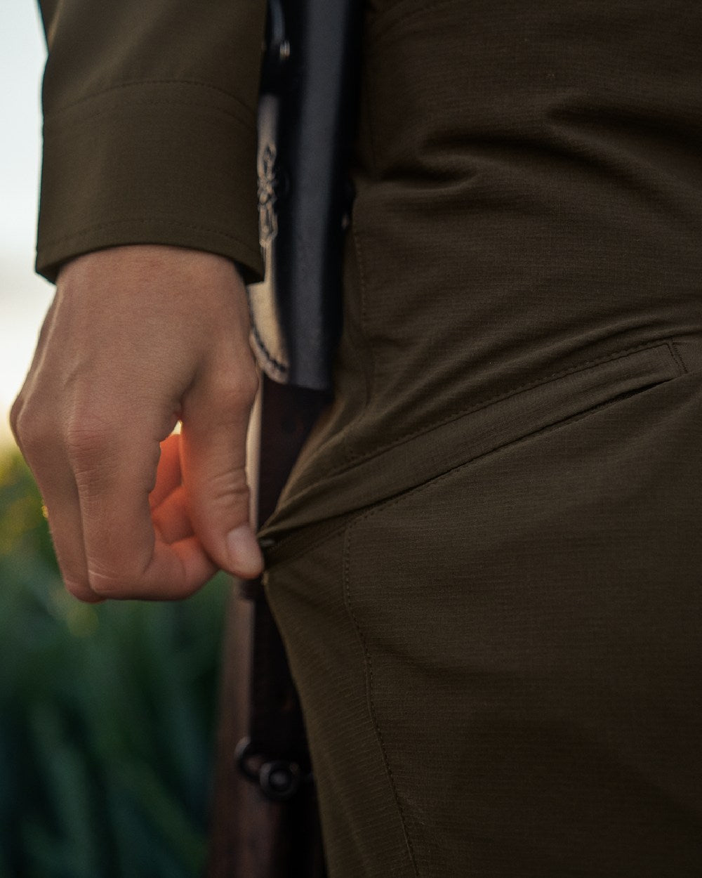 Willow Green Coloured Harkila Womens Trail Trousers on outdoor background #colour_willow-green