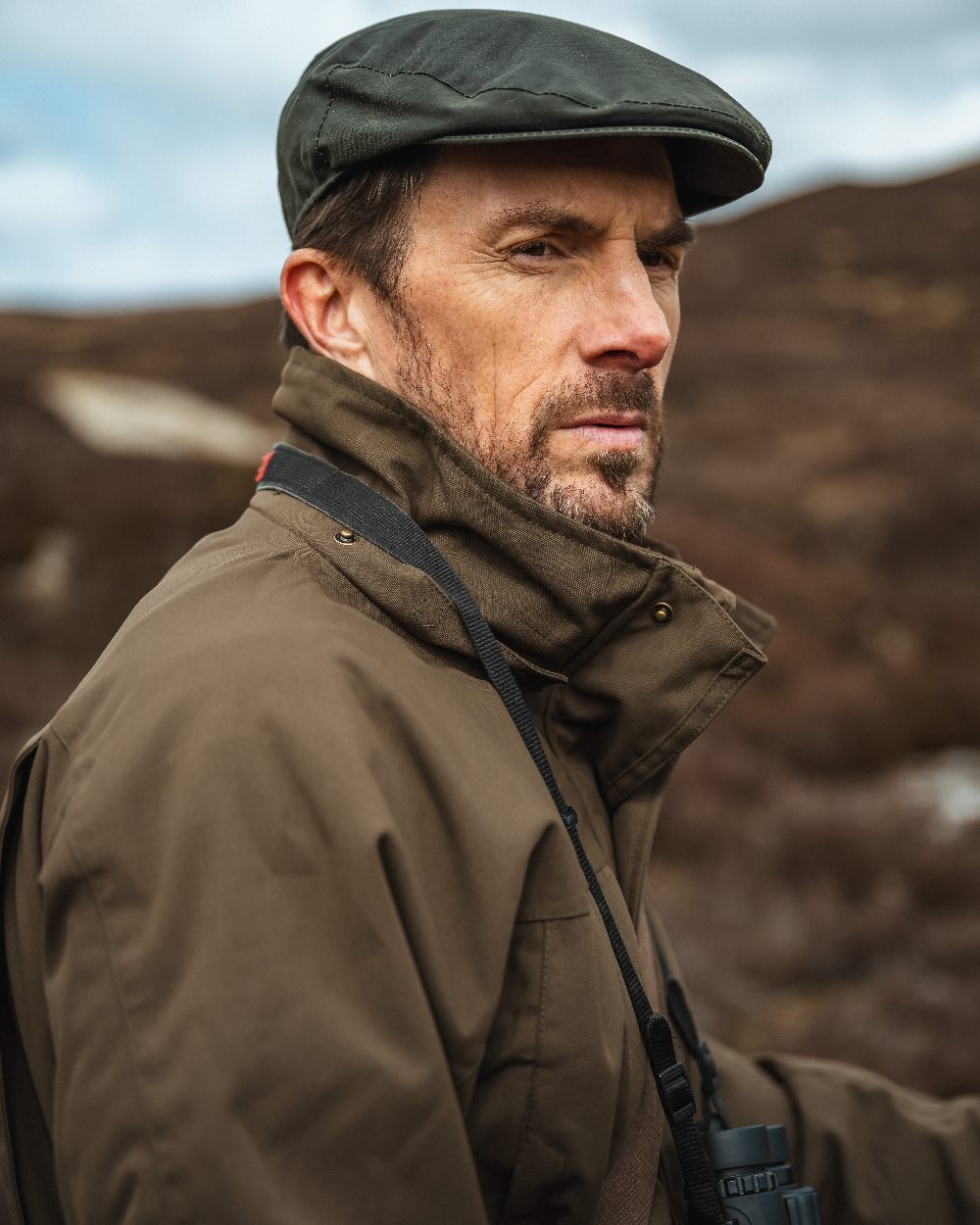 Green Coloured Hoggs of Fife Ballater Waterproof Field Jacket on blurry background #colour_green