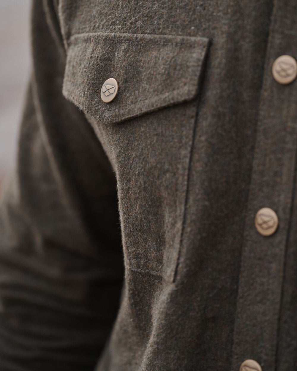 Loden Marl Coloured Hoggs of Fife Dunvegan Flannel Shirt on blurry background #colour_loden-marl