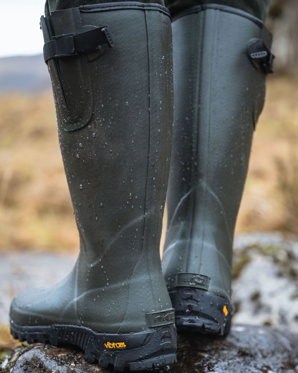 Field Green Coloured Hoggs of Fife Field Sport Neoprene Lined Wellingtons on blurry background #colour_field-green