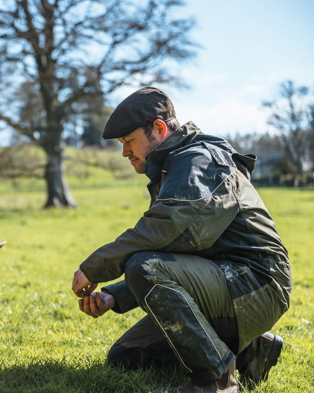 Dark Olive Coloured Hoggs of Fife Field Tech Waterproof Trousers on forest background #colour_dark-olive