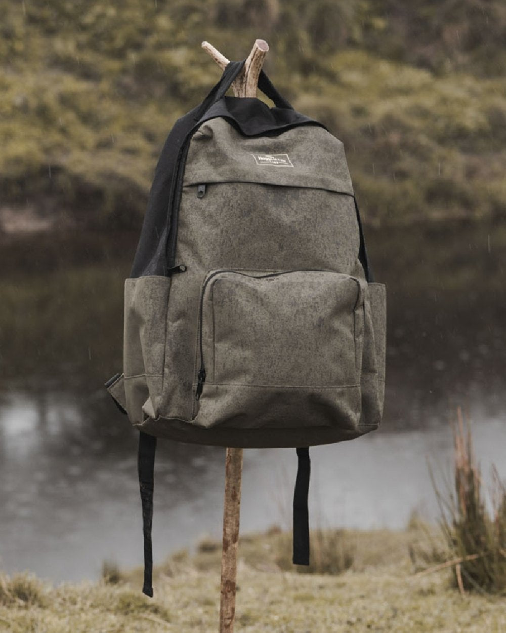 Green Black Coloured Hoggs of Fife Field & Trek Backpack on lake background #colour_green-black