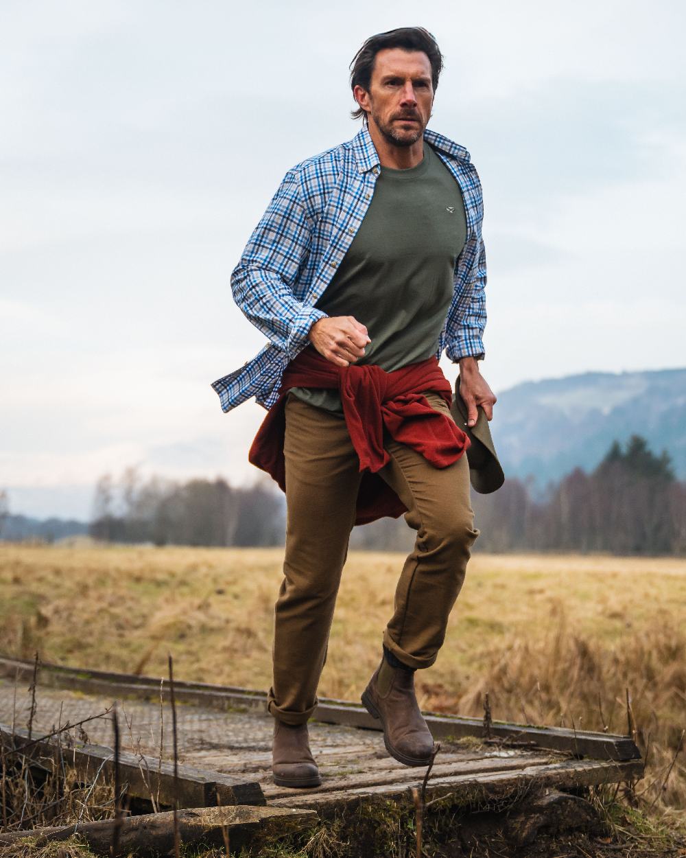 Blue Gold Check Coloured Hoggs of Fife Garvock Cotton Twill Herringbone Check Shirt on farm background #colour_blue-gold-check