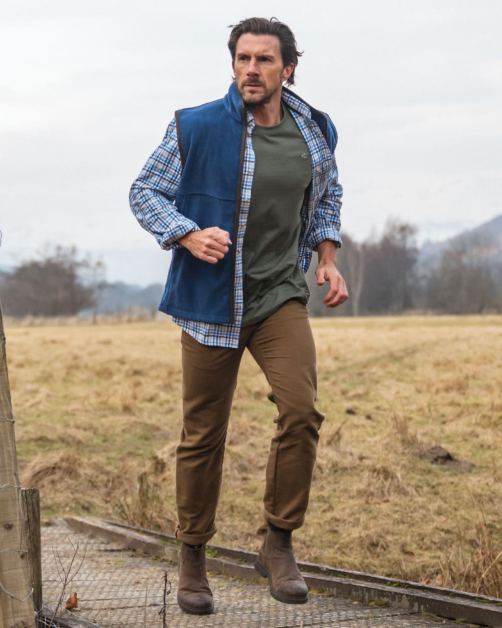 Blue Gold Check Coloured Hoggs of Fife Garvock Cotton Twill Herringbone Check Shirt on farm background #colour_blue-gold-check