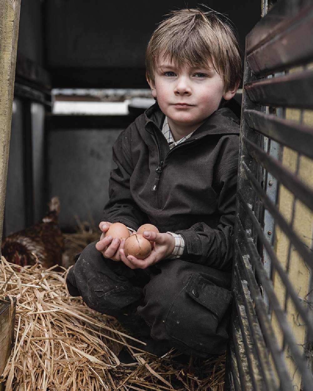 Dark Green Coloured Hoggs of Fife Junior Struther Waterproof Smock on hutch background #colour_dark-green