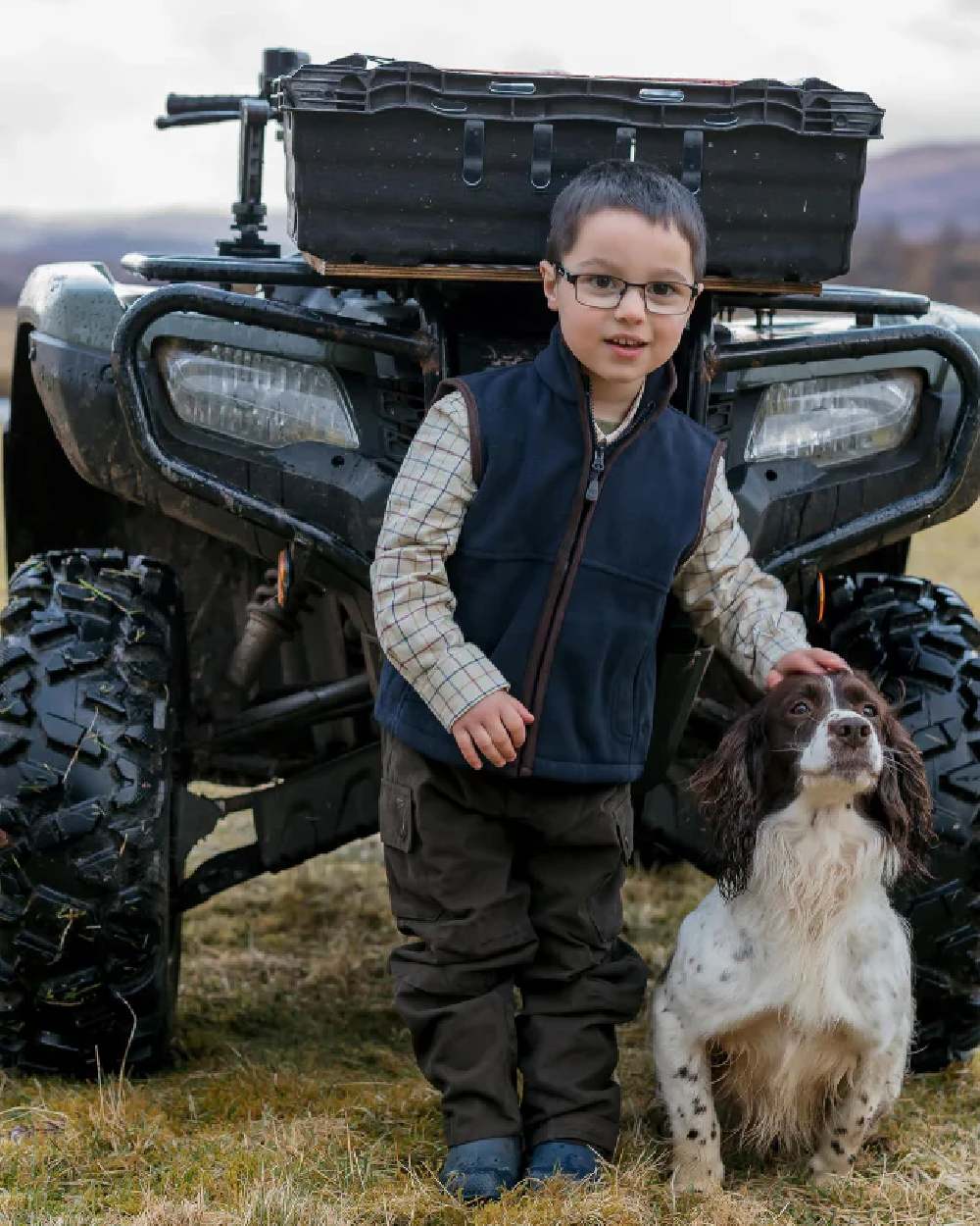 Navy Coloured Hoggs of Fife Junior Woodhall Fleece Gilet on tractor background #colour_navy