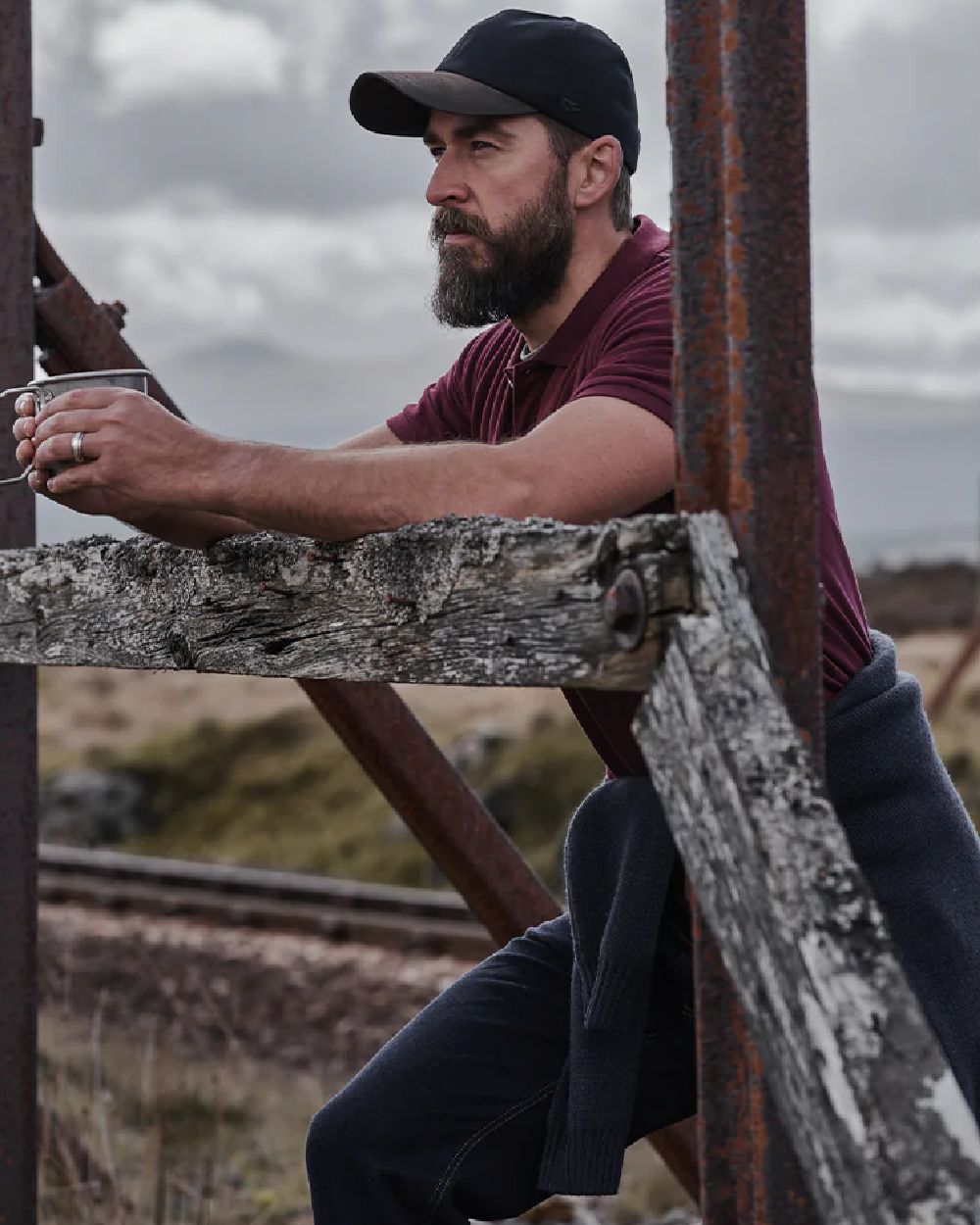 Bordeaux Coloured Hoggs of Fife Largs Pique Polo Shirt on mountain background #colour_bordeaux