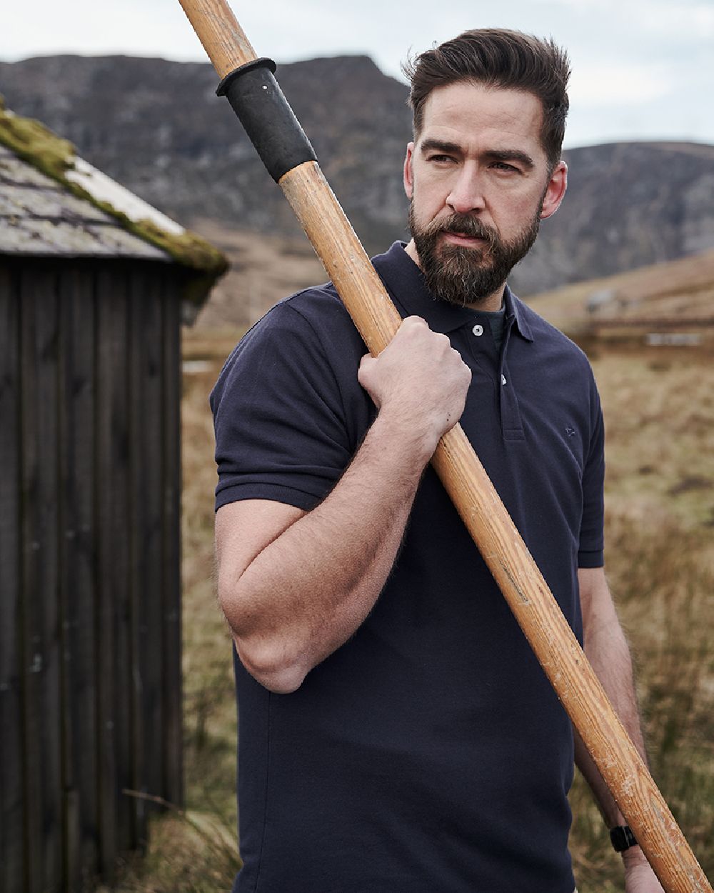 Navy Coloured Hoggs of Fife Largs Pique Polo Shirt on mountain background #colour_navy