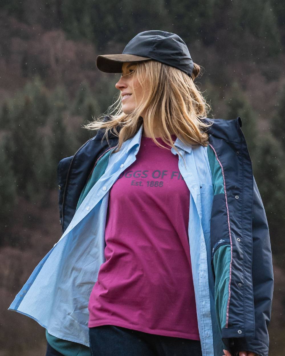 Navy Coloured Hoggs of Fife Leather Peak Waxed Baseball Cap on blurry background #colour_navy