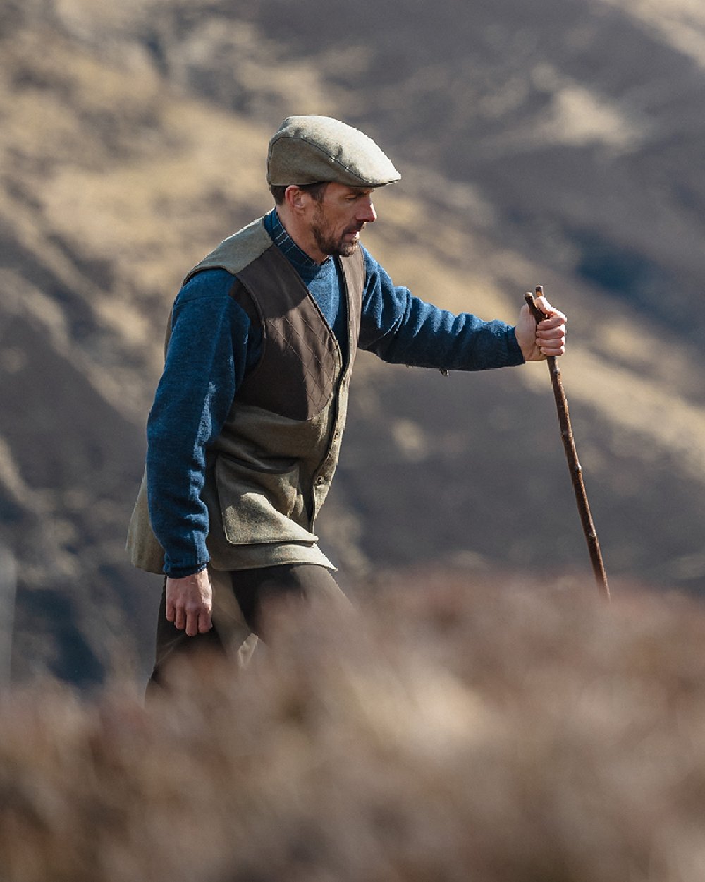 Storm Blue coloured Hoggs of Fife Melrose II Crew Pullover on blurry background #colour_storm-blue