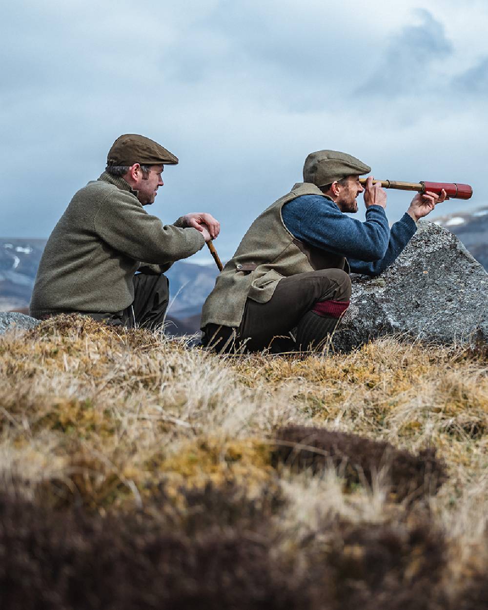 Storm Blue coloured Hoggs of Fife Melrose II Crew Pullover on mountain background #colour_storm-blue