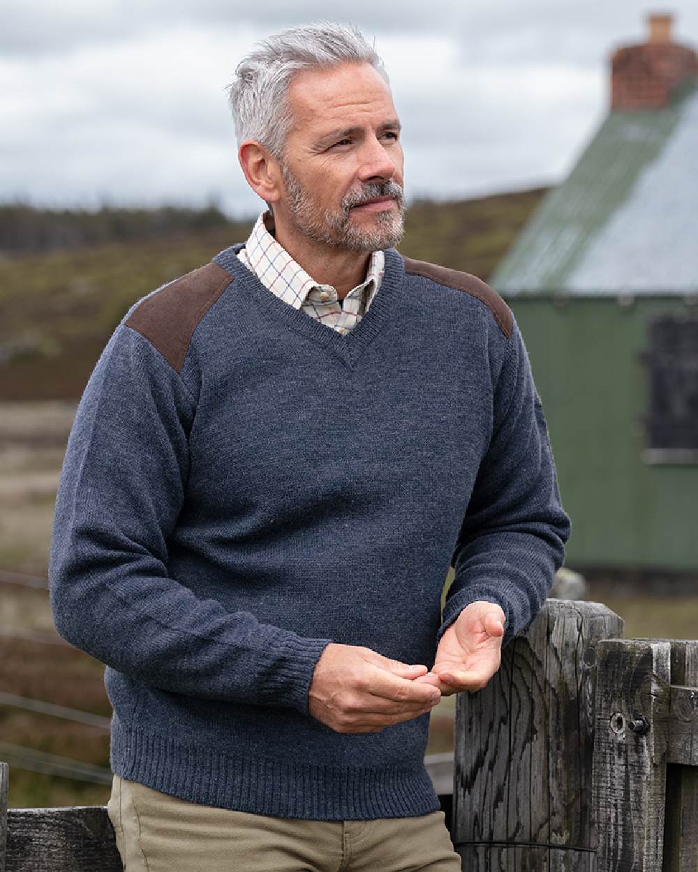 Storm Blue coloured Hoggs of Fife Melrose II V Neck Pullover on countryside background #colour_storm-blue