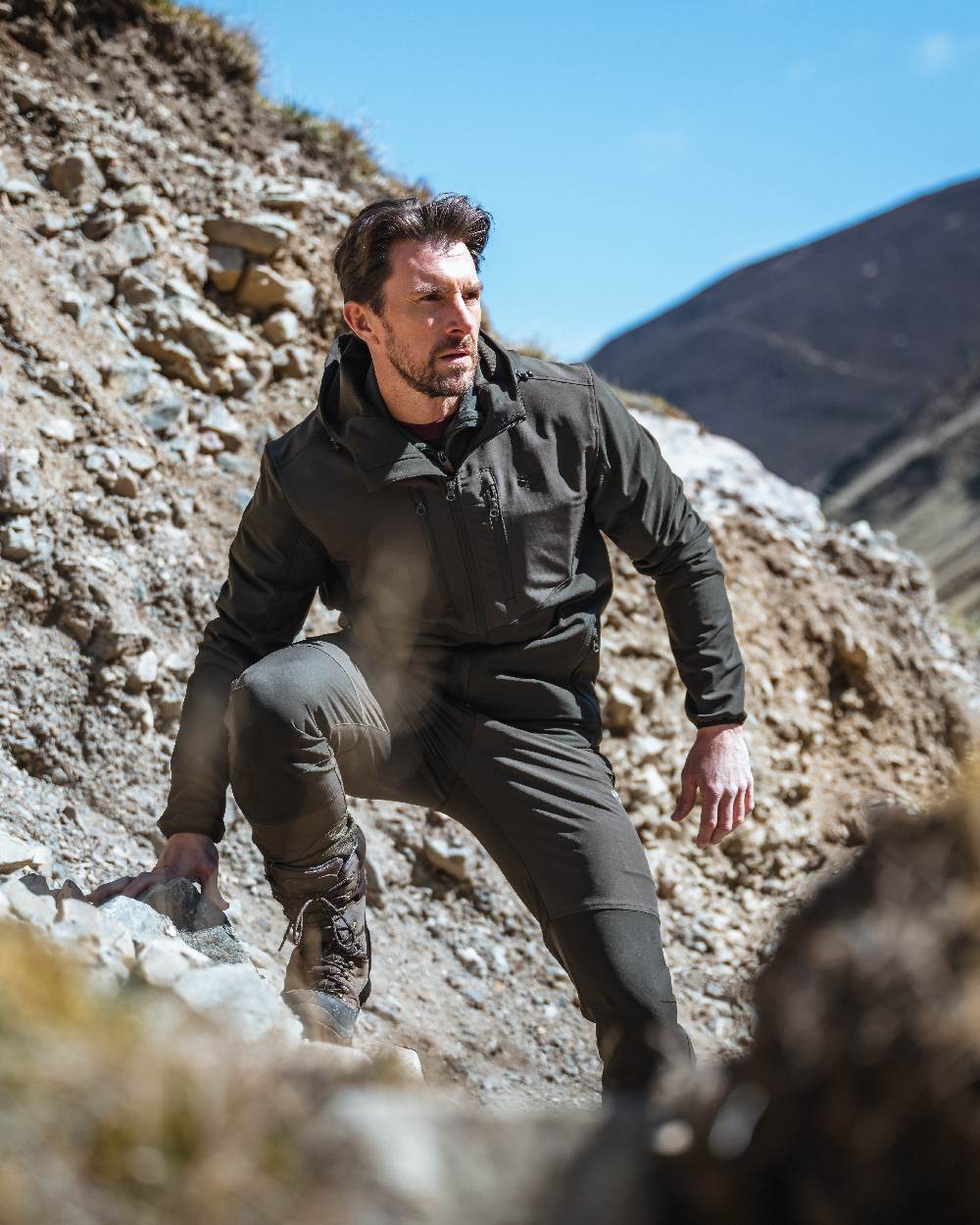 Green Coloured Hoggs of Fife Mens Ardross 4 Way Active Trousers on mountain background #colour_green