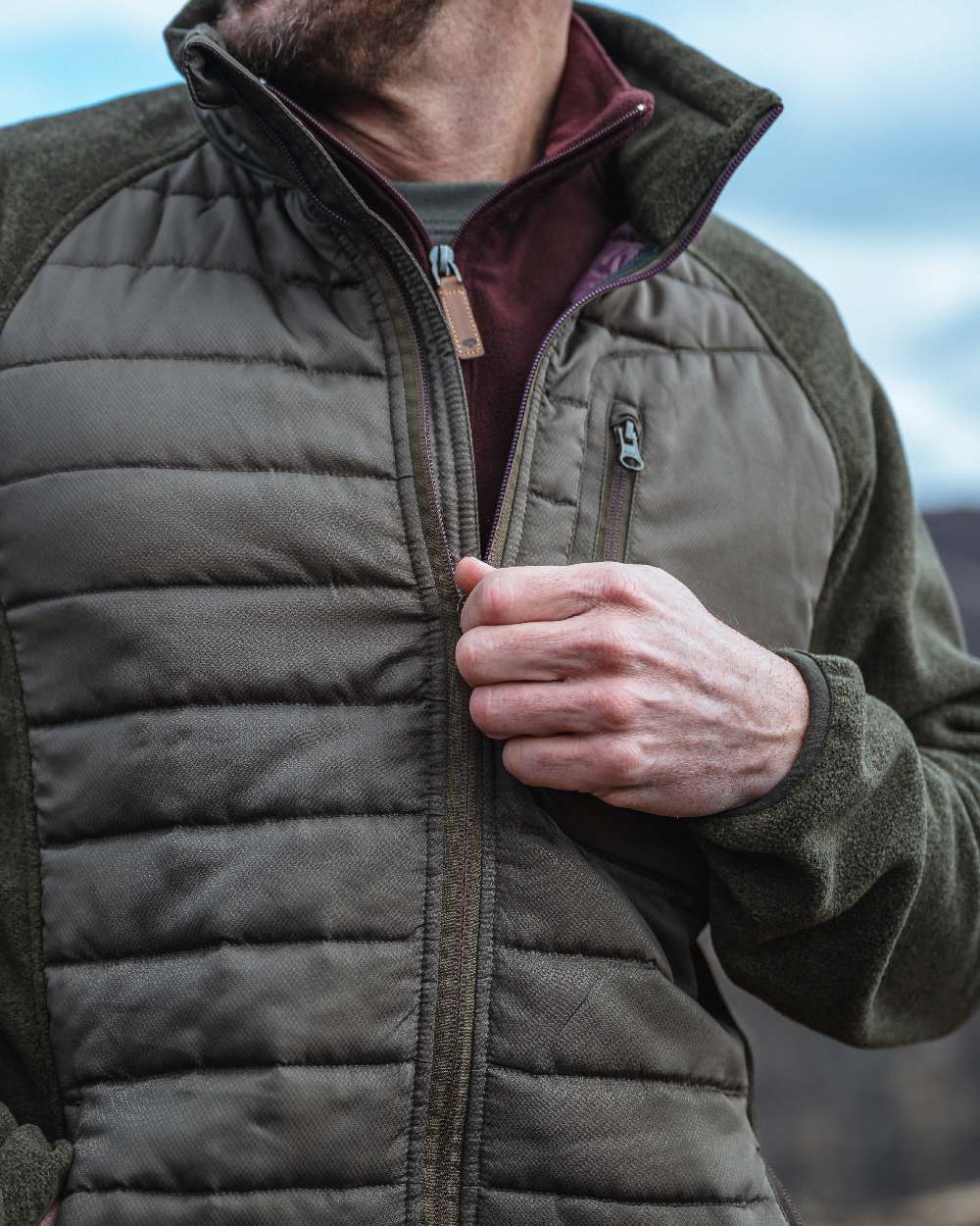 Dark Forest Marl Coloured Hoggs of Fife Mens Melville Hybrid Jacket on blurry background #colour_dark-forest-marl
