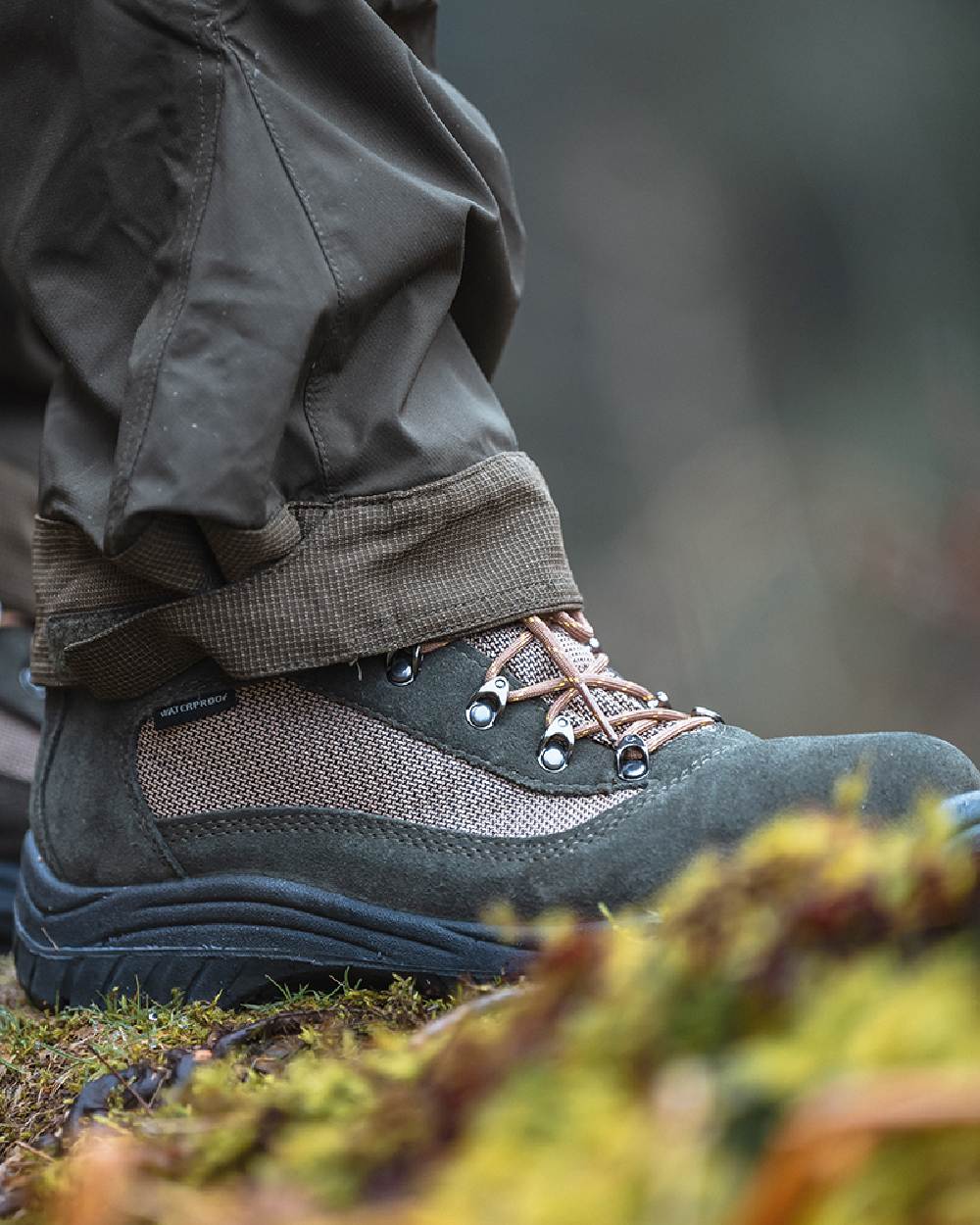 Fern Green Coloured Hoggs of Fife Rambler Waterproof Hiking Boots on blurry background #colour_fern-green