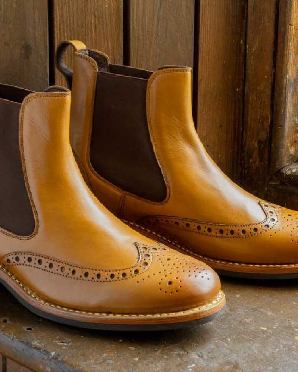 Burnished Tan Coloured Hoggs of Fife Stanley Semi-Brogue Dealer Boots on wood background #colour_burnished-tan