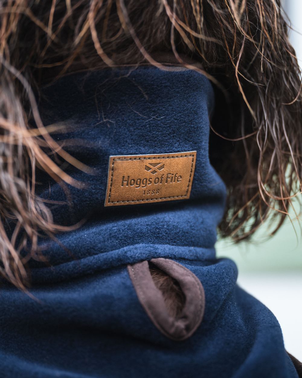 Navy Coloured Hoggs of Fife Stenton Fleece Dog Coat on blurry background #colour_navy