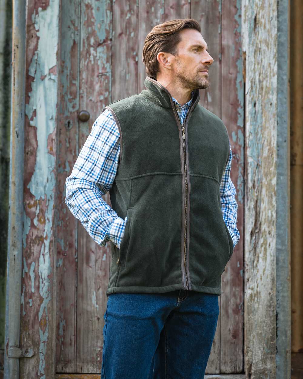 Pine Green coloured Hoggs of Fife Stenton Technical Fleece Gilet on forest background #colour_pine-green
