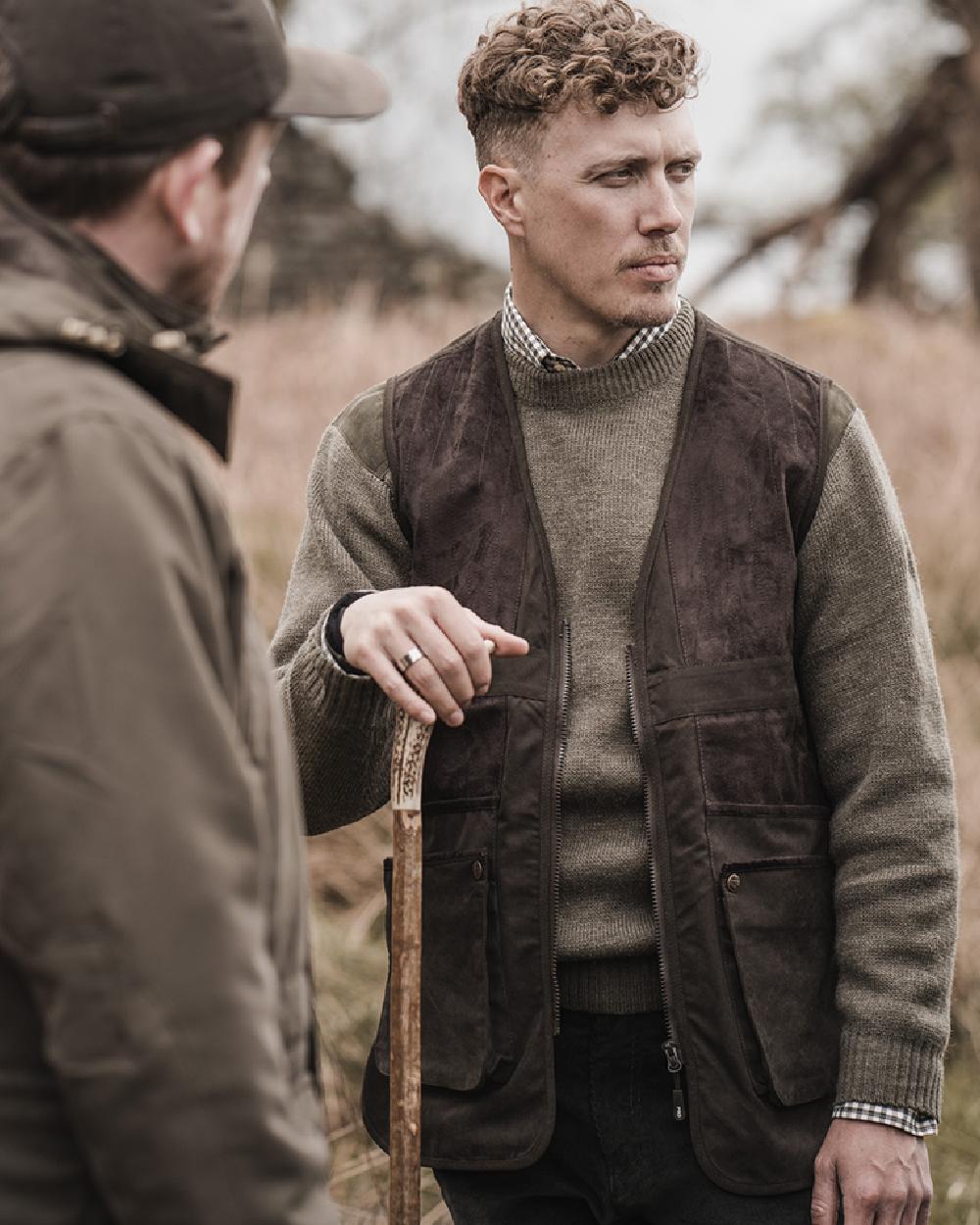 Dark Green coloured Hoggs of Fife Struther Shooting Vest on forest background #colour_dark-green