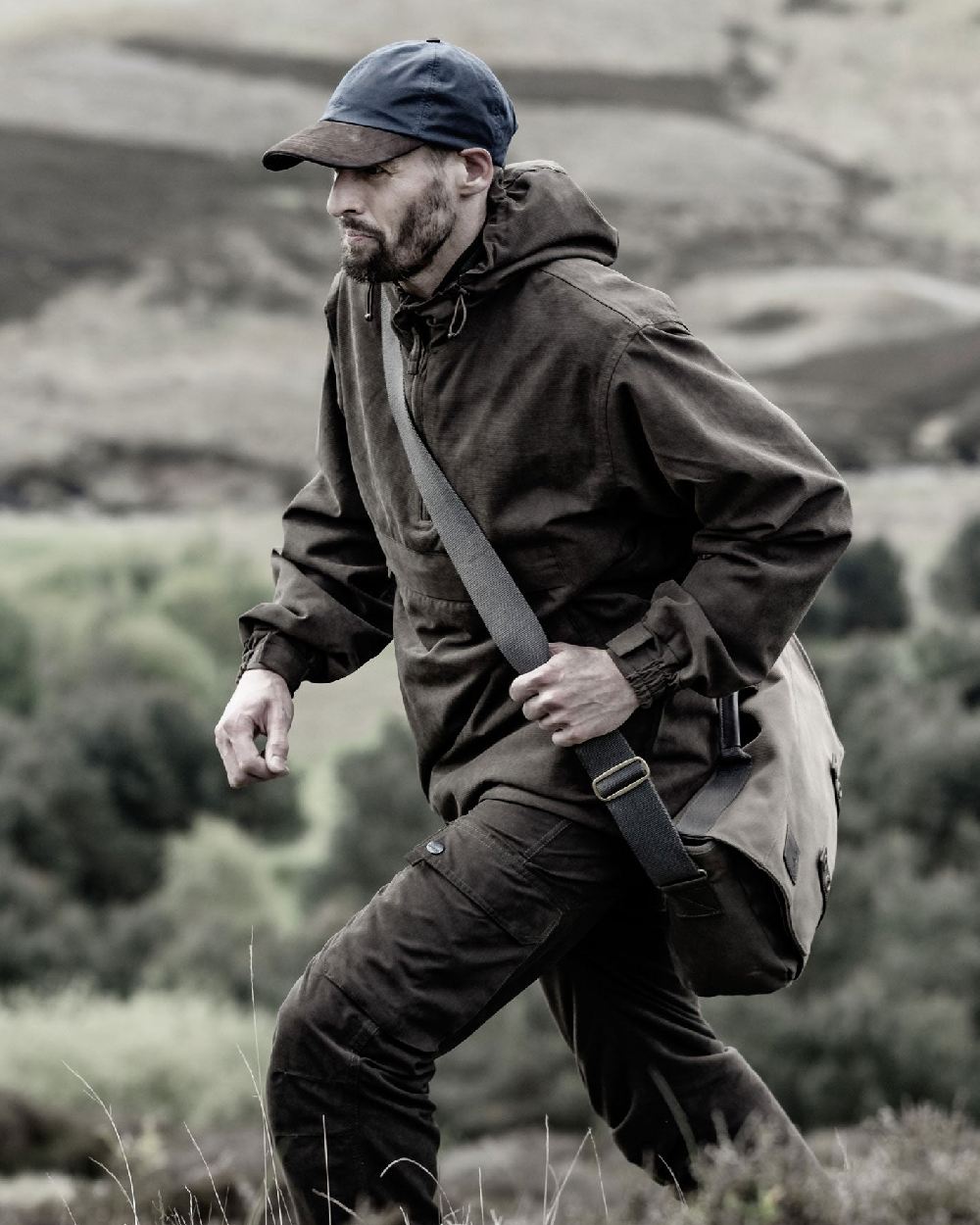 Dark Green coloured Hoggs of Fife Struther Waterproof Smock Jacket on forest background #colour_dark-green