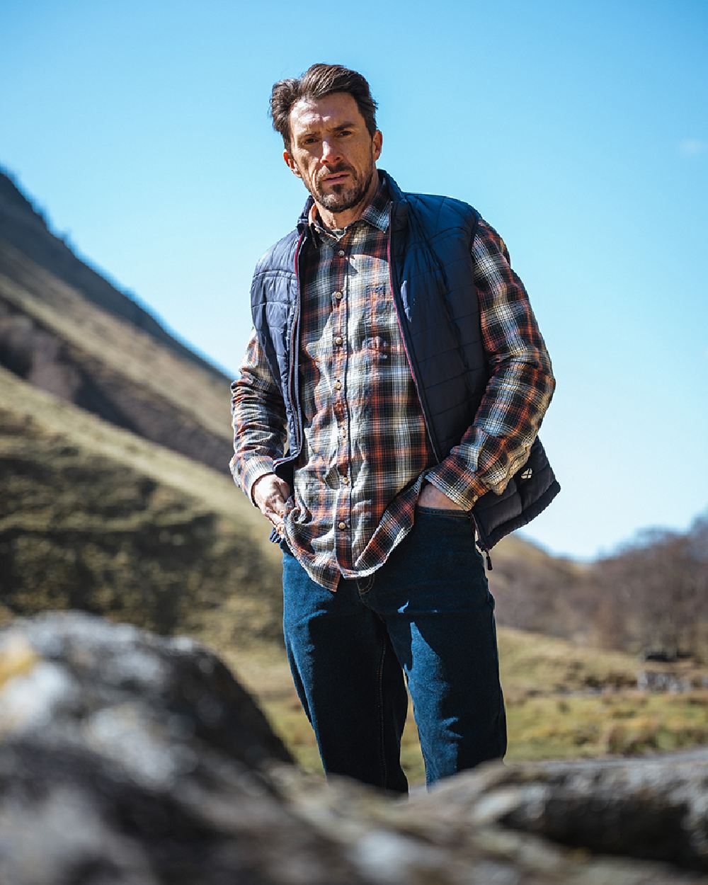 Rust Olive Navy coloured Hoggs of Fife Tiree Herringbone Check Shirt on mountain background #colour_rust-olive-navy