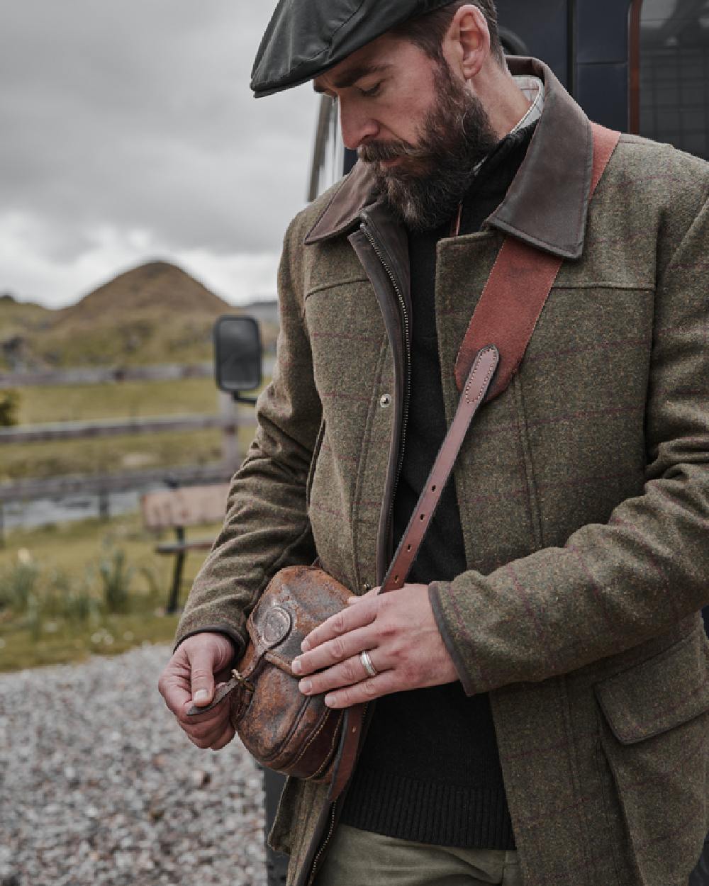 Olive Wine Coloured Hoggs of Fife Tummel Tweed Field Coat on mountain background #colour_olive-wine