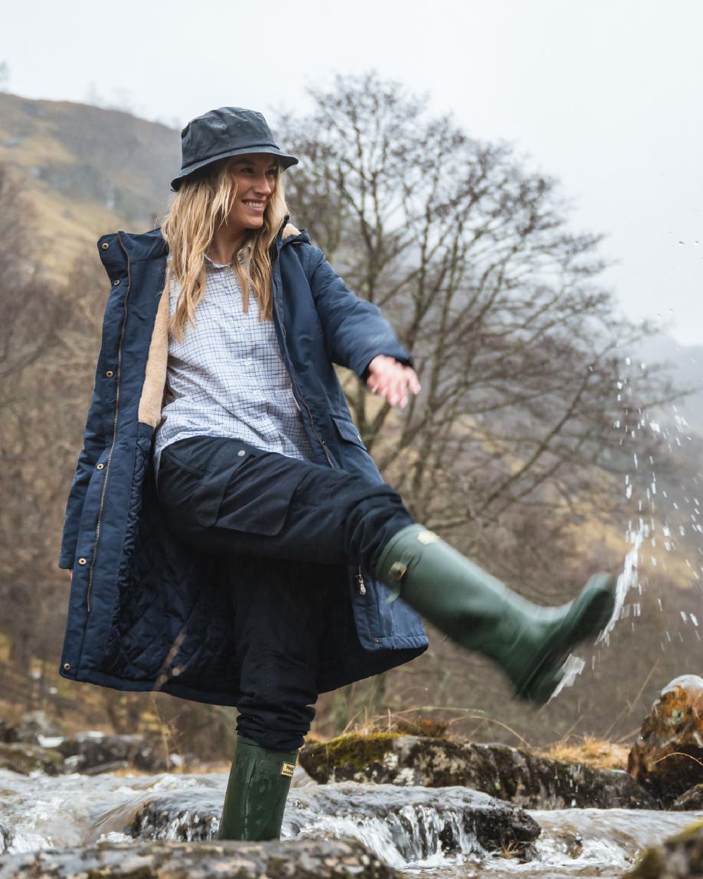 Navy Coloured Hoggs of Fife Waxed Bush Hat on forest background #colour_navy