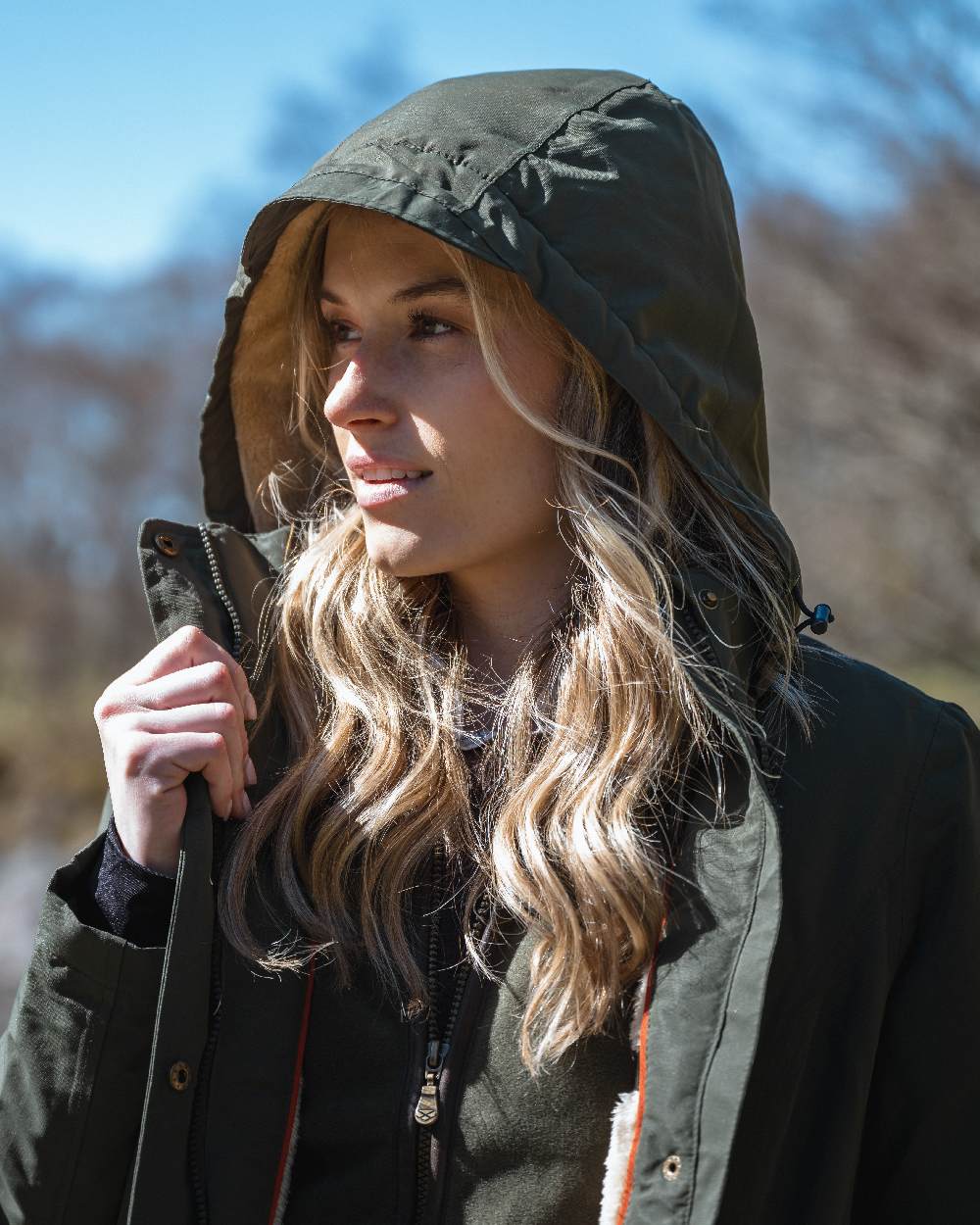 Green coloured Hoggs of Fife Womens Walker Long Coat on blurry background #colour_green