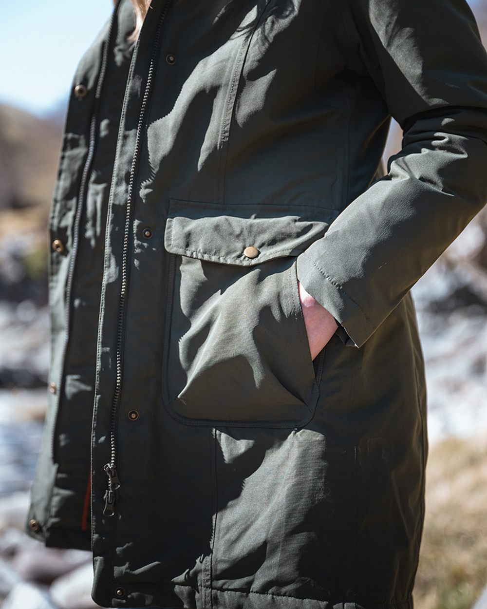 Green coloured Hoggs of Fife Womens Walker Long Coat on blurry background #colour_green