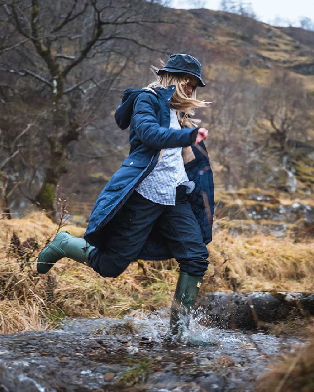 Navy coloured Hoggs of Fife Womens Walker Long Coat on forest background #colour_navy