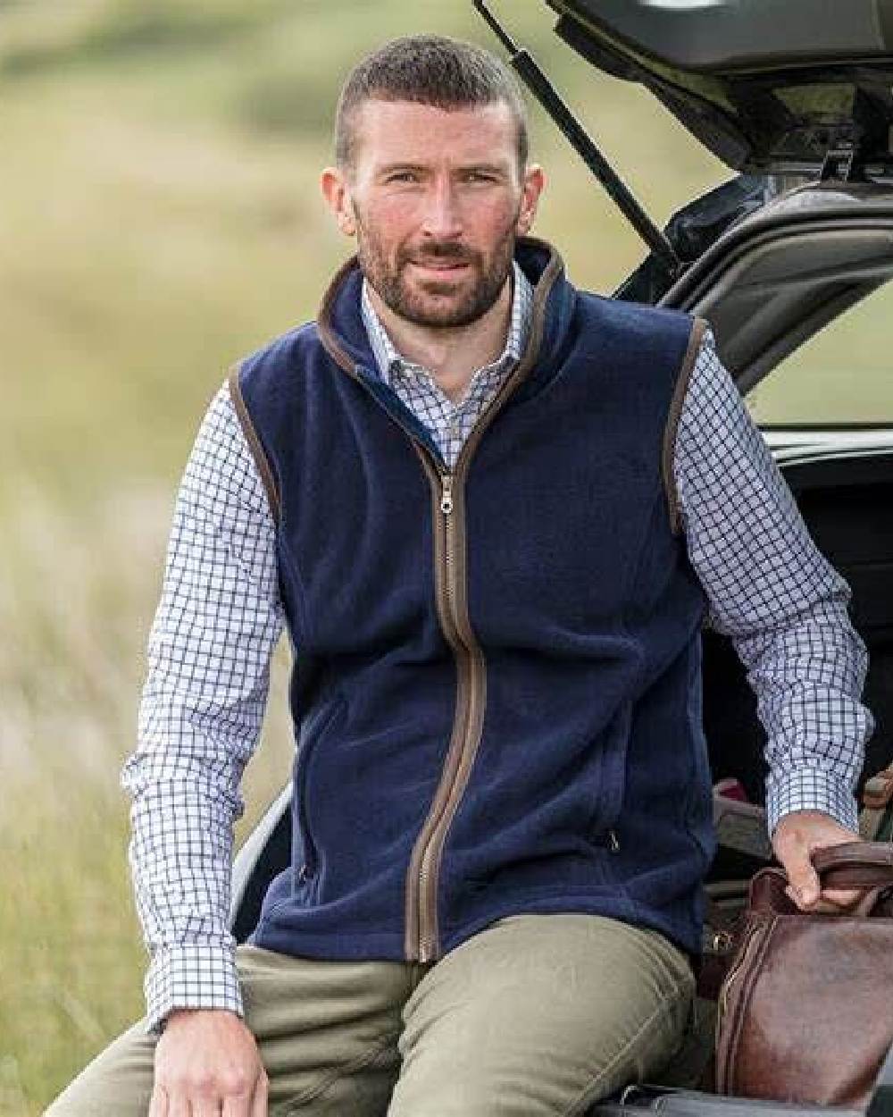 Navy Coloured Hoggs of Fife Woodhall Fleece Gilet on car background #colour_navy