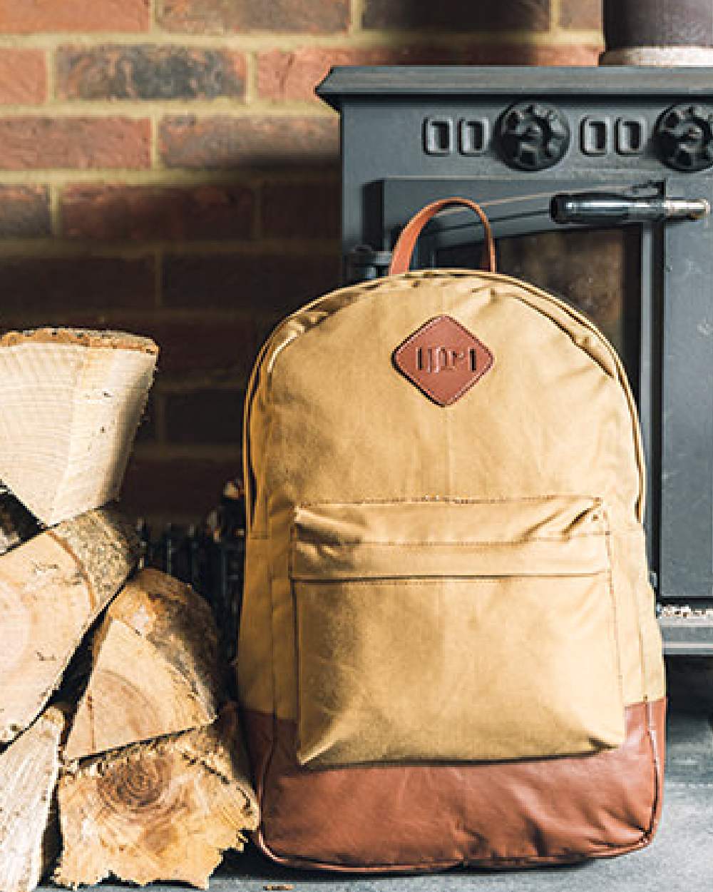 Fawn coloured Jack Pyke Canvas Back Pack on brick wall background #colour_fawn
