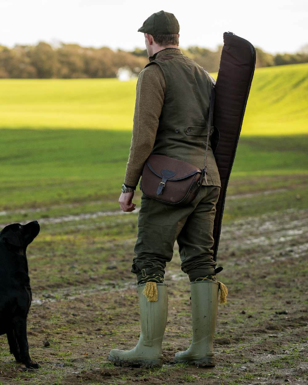 Brown coloured Jack Pyke Canvas Cartridge Bag on grassy background #colour_brown