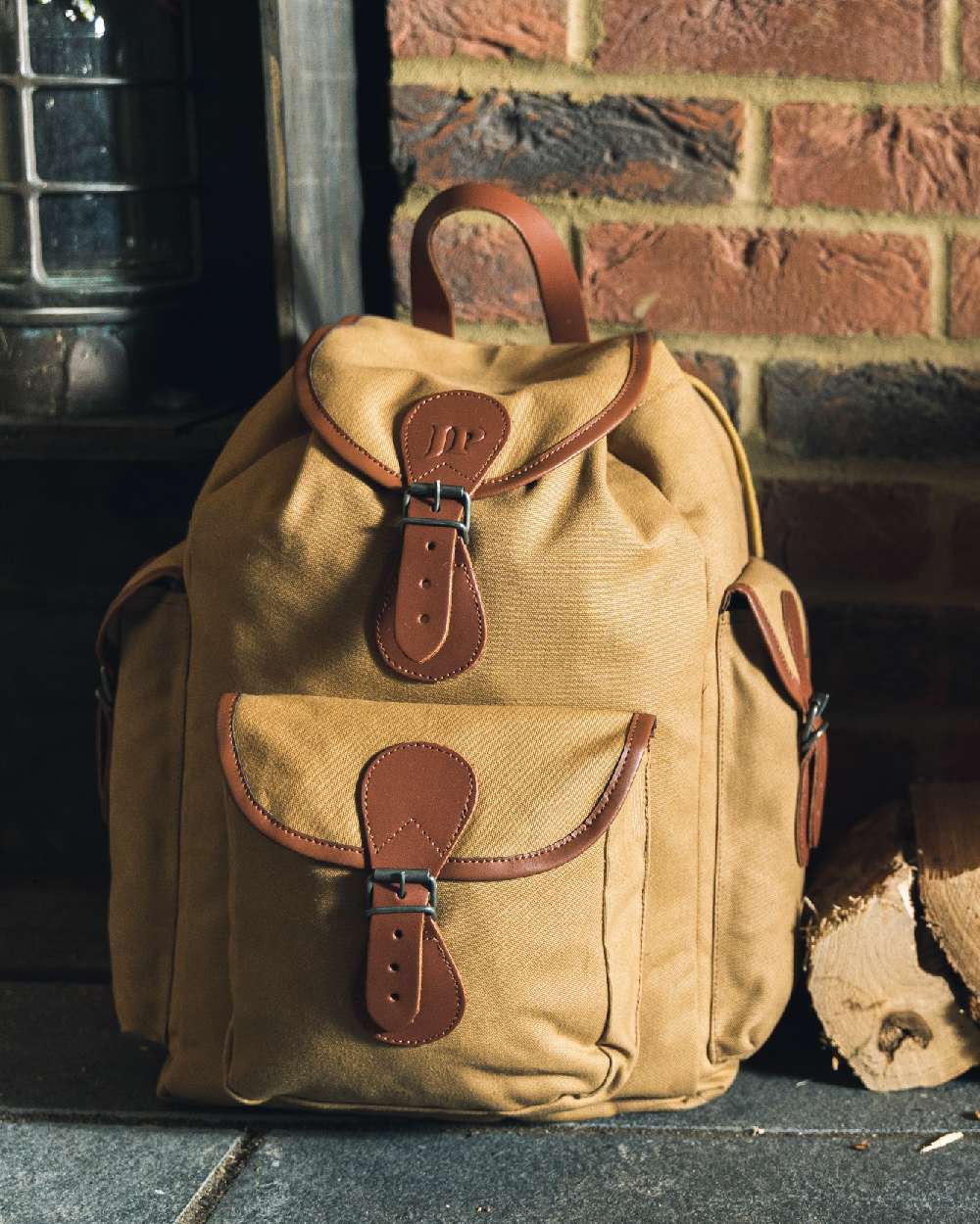Fawn coloured Jack Pyke Canvas Day Pack on wall background #colour_fawn