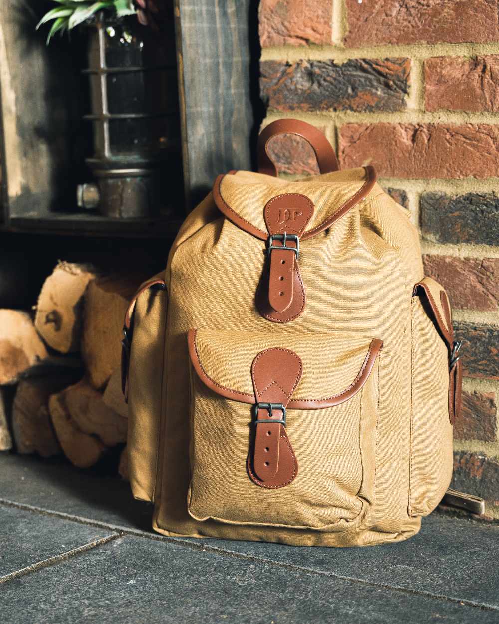 Fawn coloured Jack Pyke Canvas Day Pack on wall background #colour_fawn